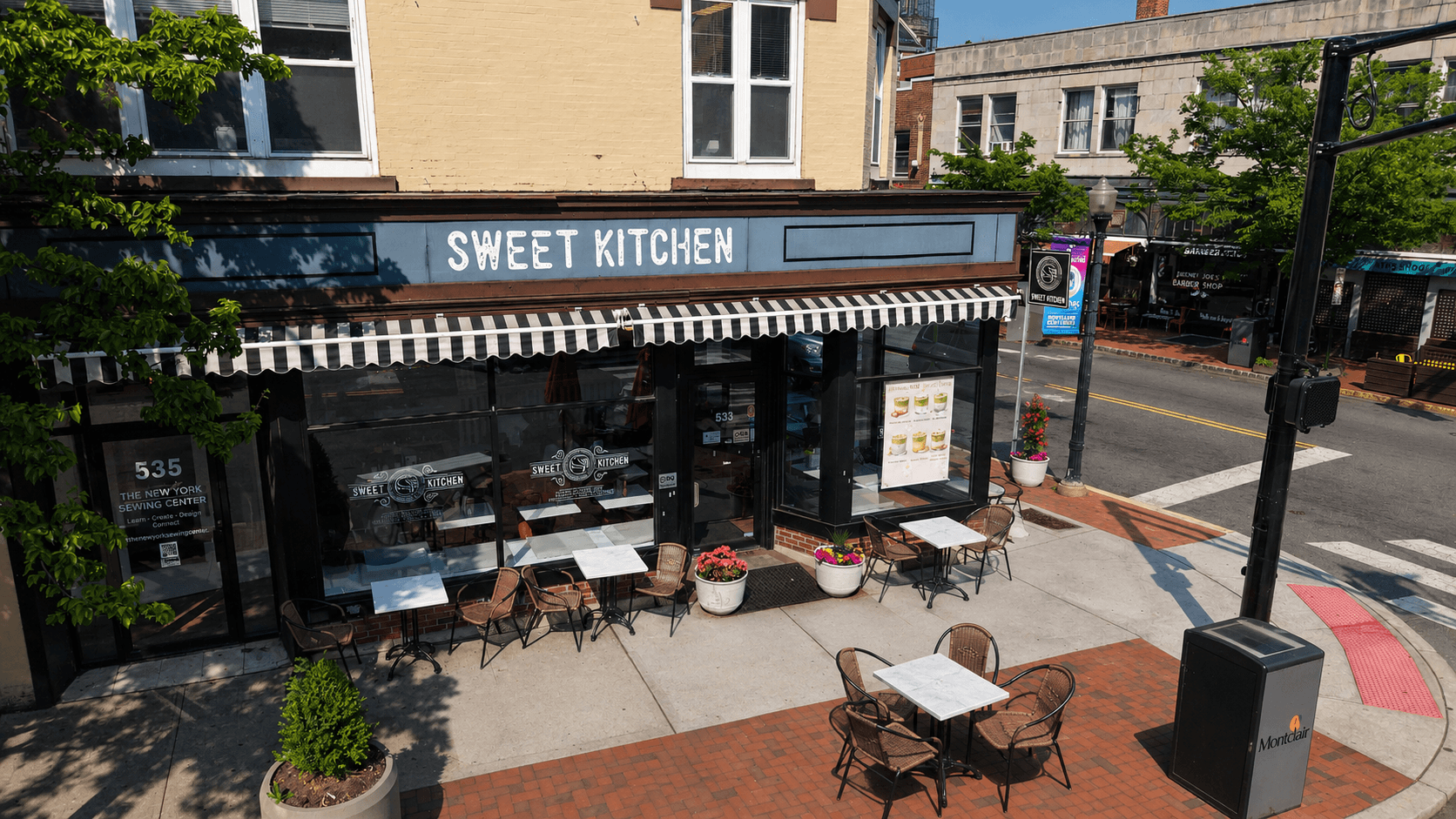 Elevated storefront photo of Sweet Kitchen café in Montclair, New Jersey — striped awning and sidewalk café seating